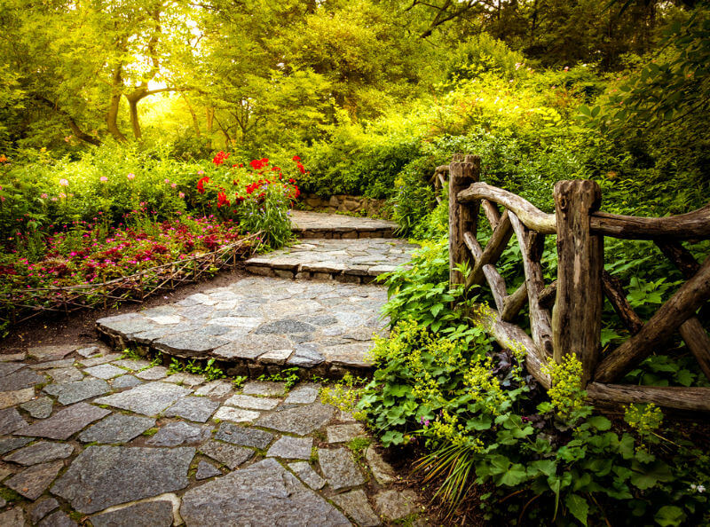 Storybook garden path with stone paved steps and branch fencing