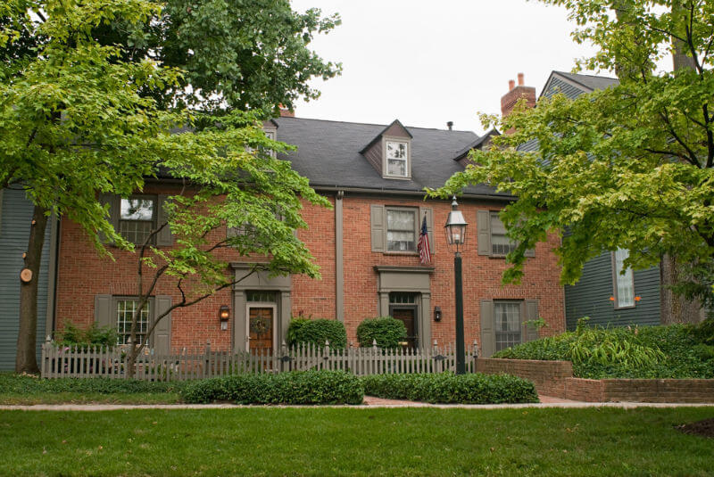 town house with decorative gray fencing in front yard