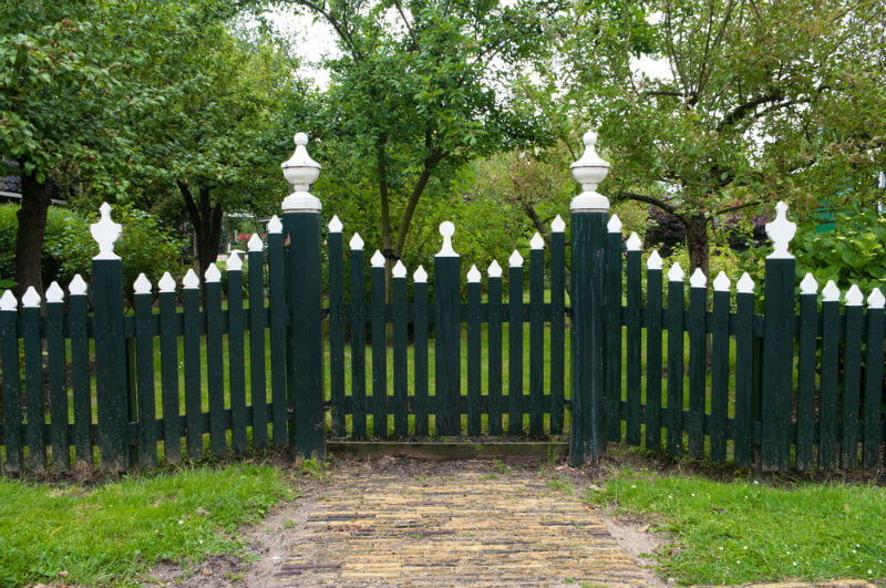black wooden picket fence with white tops