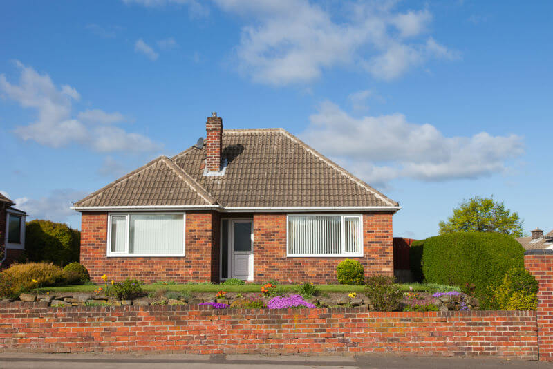 bungalow with red brick fence