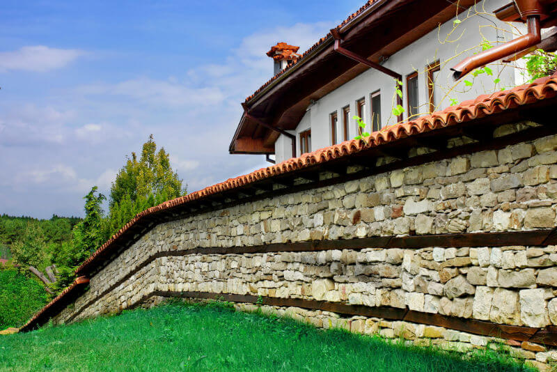 house with stone brick fencing and roof tile