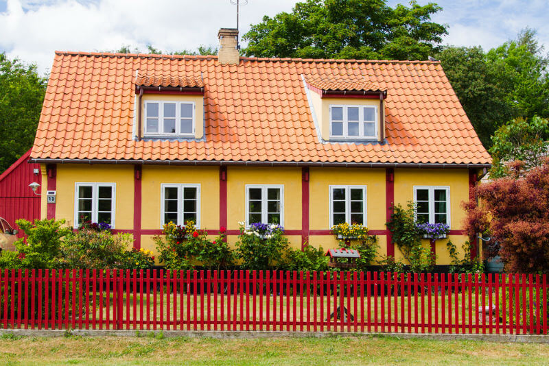 Timbered house with red picket fence